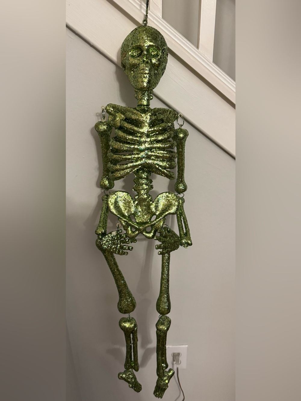 Skeleton. A beautiful, decorative green glittery hanging skeleton—perfect as a f